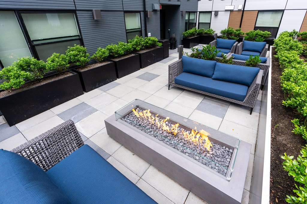 A modern outdoor seating area with a fire pit.