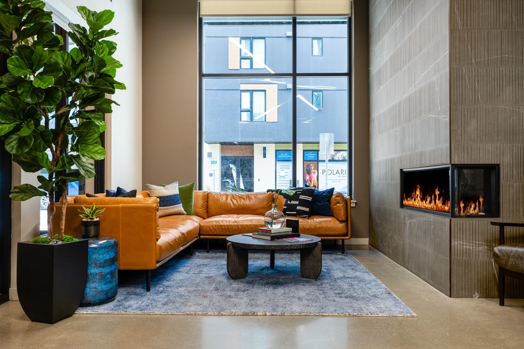 A living room with a fireplace and a large window.