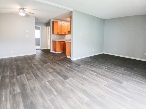 A room with wooden flooring and a ceiling fan.