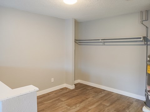 A room with a white ceiling and a wooden floor.