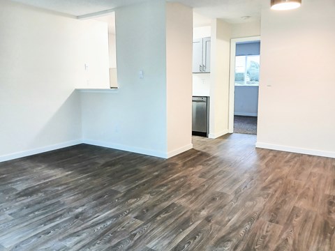 A room with a wooden floor and white walls.