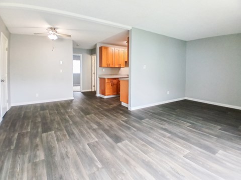A room with wooden flooring and a ceiling fan.