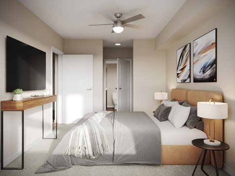A modern bedroom with a large bed and a ceiling fan.