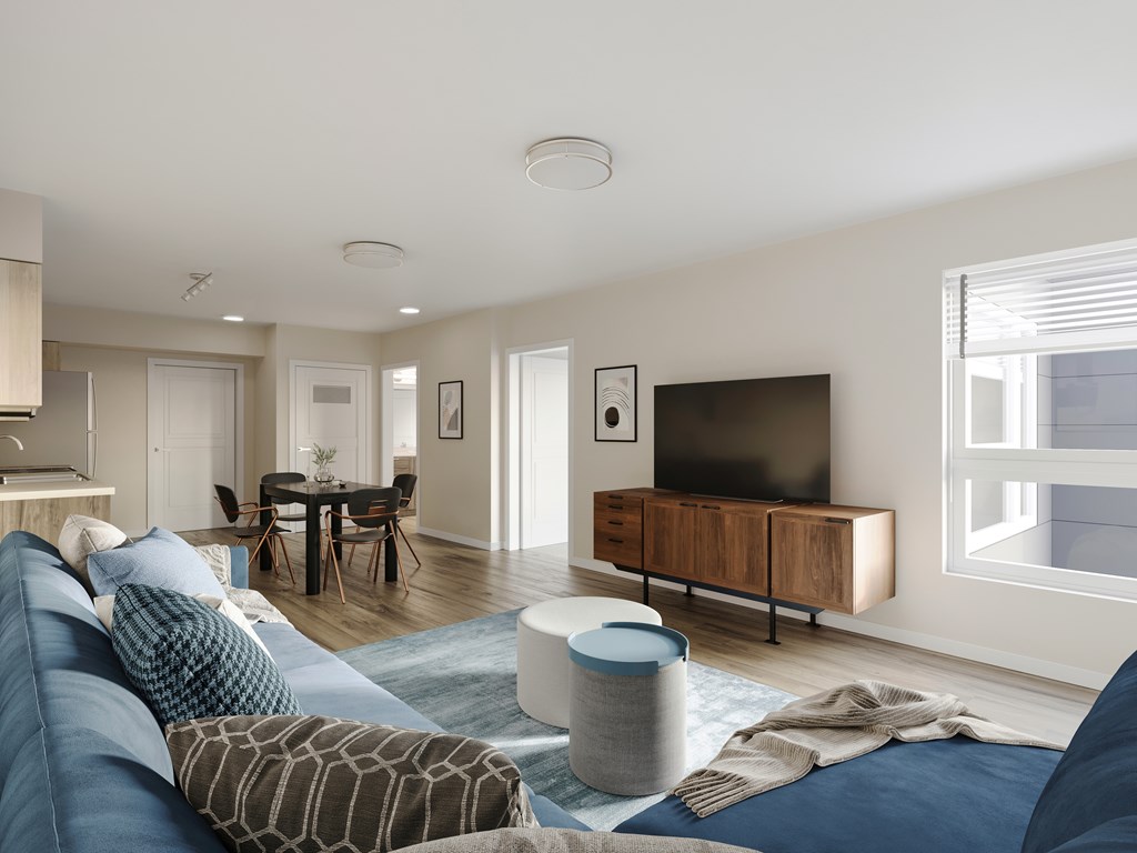 A modern living room with a blue sofa and a television.