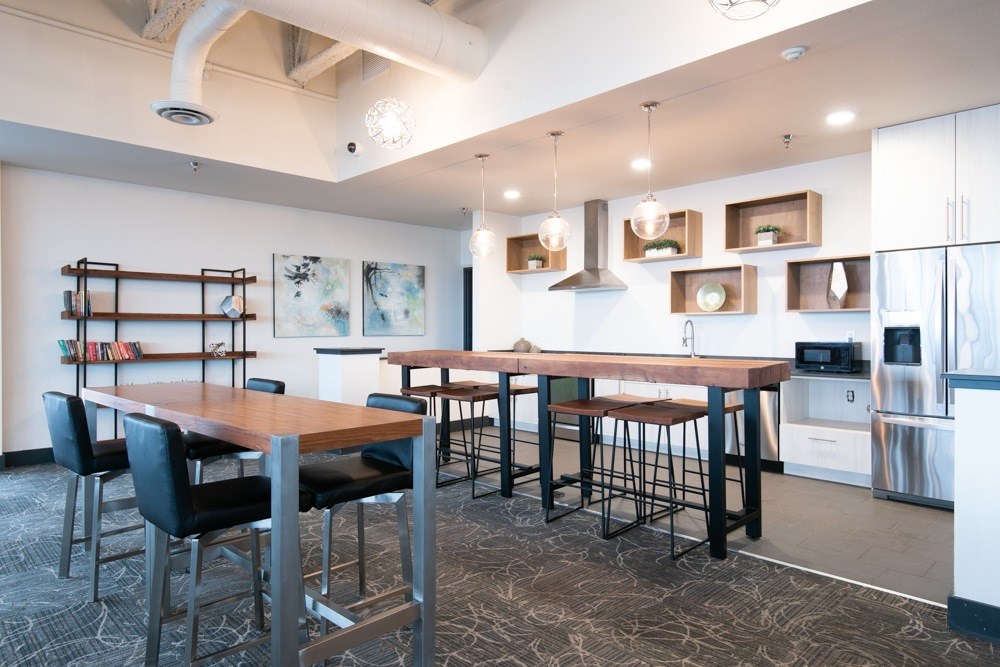 A modern kitchen with a dining table and chairs.