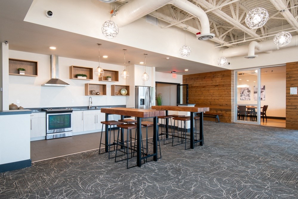 A kitchen with a bar area and a dining table.