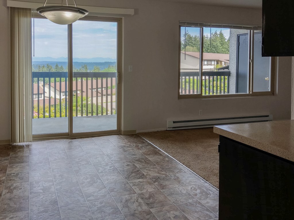 A room with a sliding glass door leading to a balcony.
