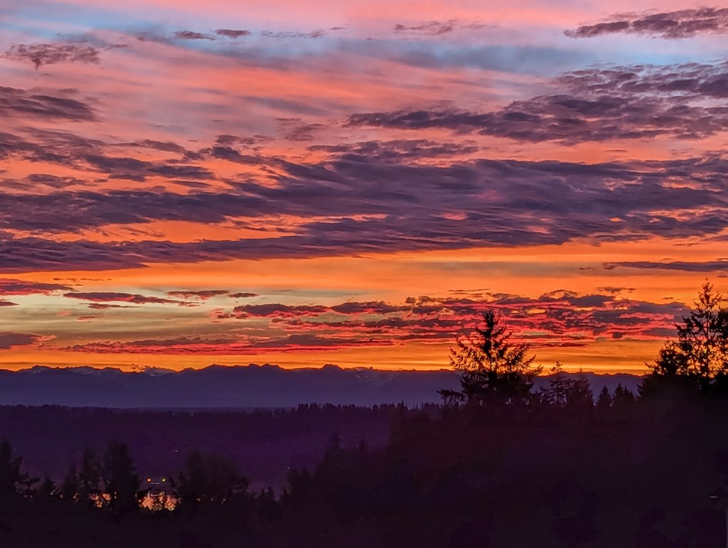 A beautiful sunset with a mix of orange, pink, and purple hues in the sky.
