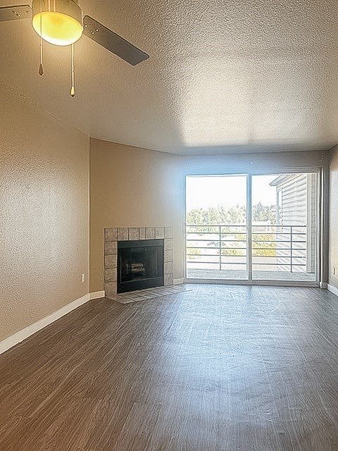 A room with a fireplace and sliding glass doors.