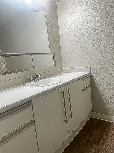 A white sink is on a white countertop.