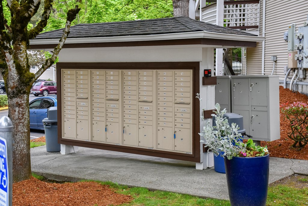 A brown and beige garage door with a tree in front of it.