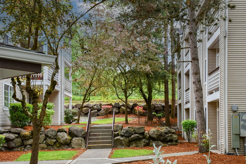 A residential area with a stone wall and a staircase.
