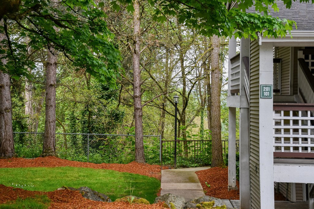 A house numbered 201 sits in front of a tree-lined yard.