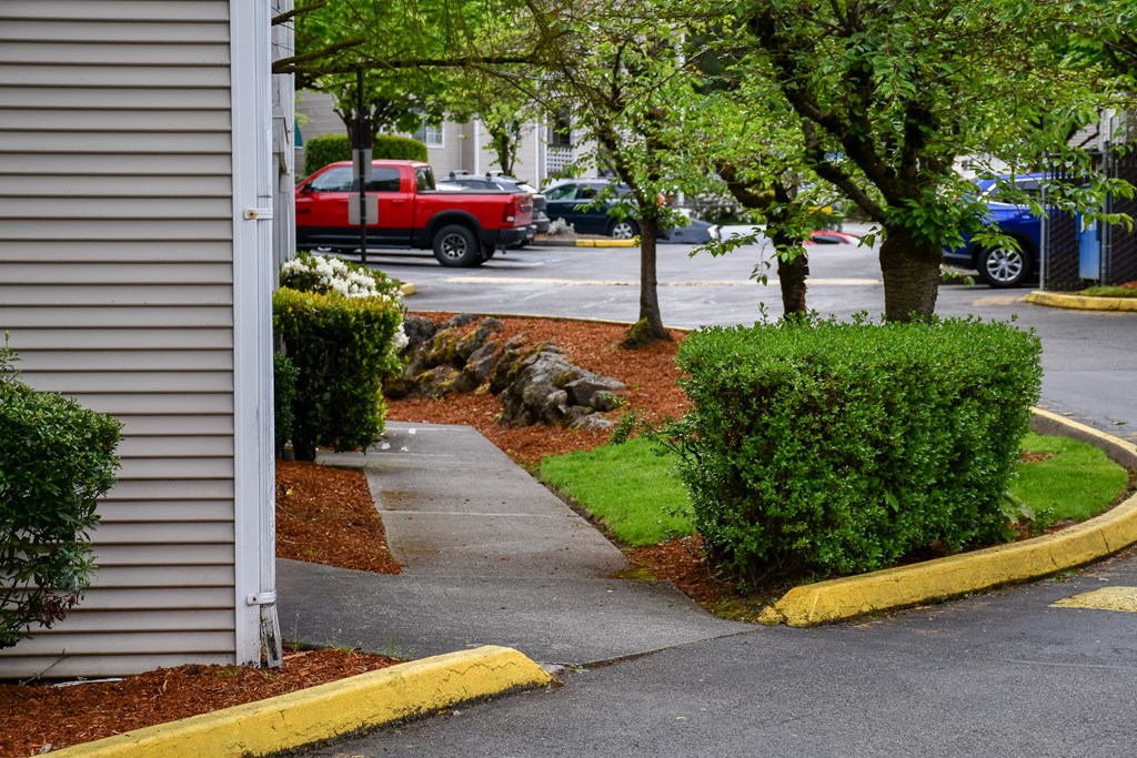 A red truck is parked in a parking lot.