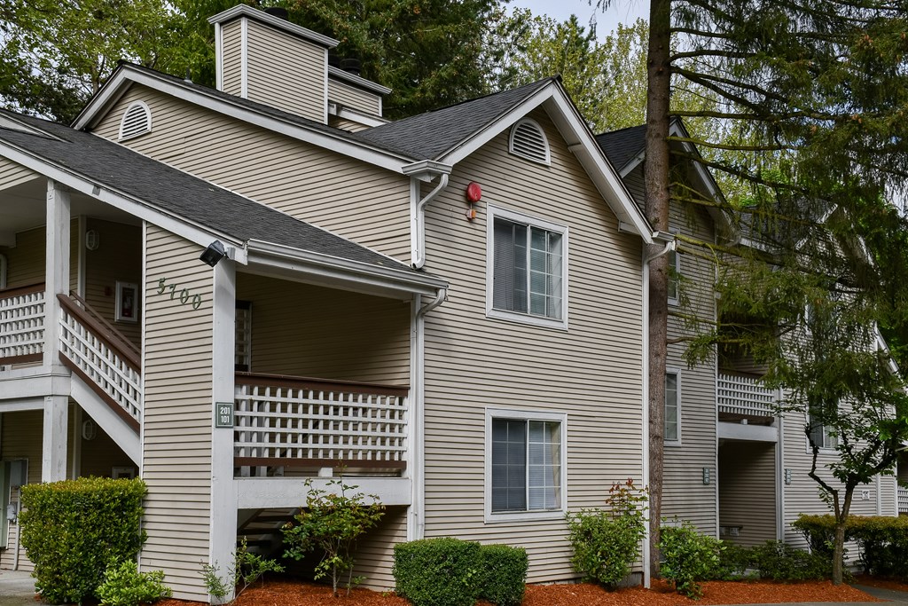 A two-story house with a balcony on the second floor.