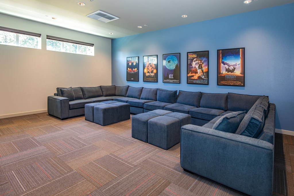 A living room with a grey sofa and ottoman.