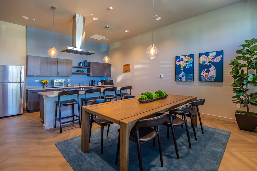 A modern kitchen with a dining table and chairs.