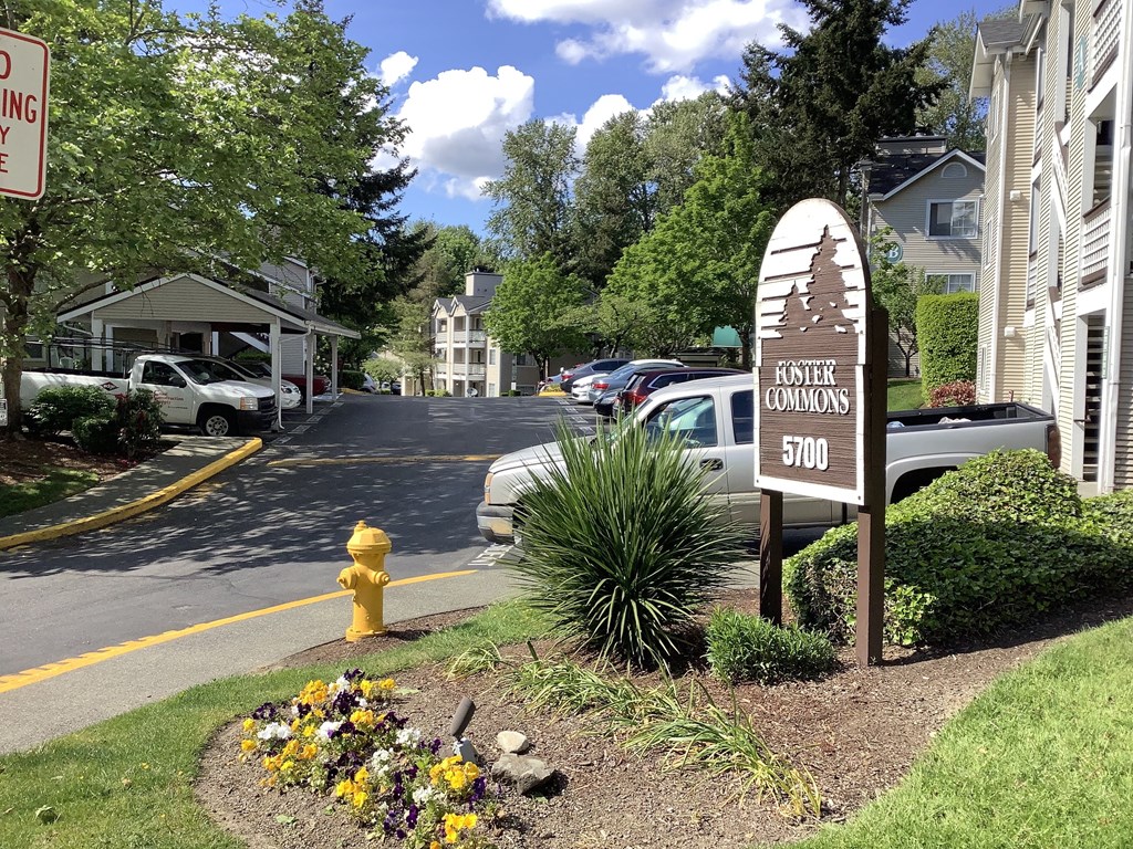 A sign for Buster Commons is in front of a building.