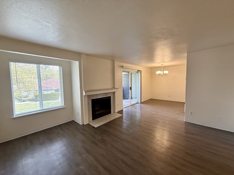 A living room with a fireplace and a sliding glass door.