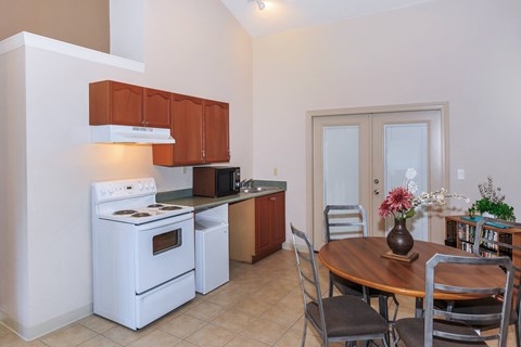 A kitchen with a white stove and brown cabinets.
