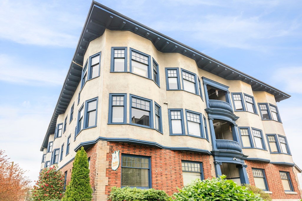 A large building with a curved corner and a blue trim.