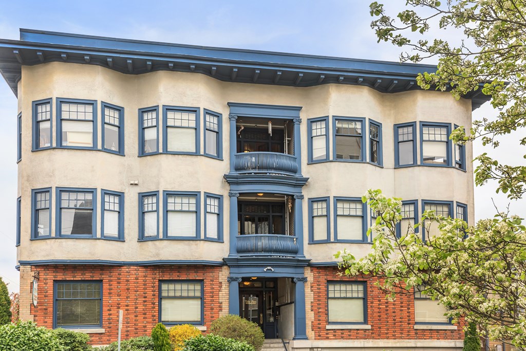 A building with a blue awning and a balcony.