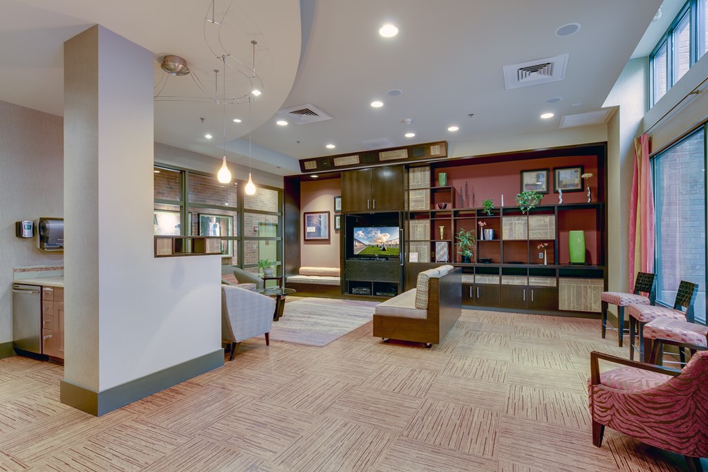 A spacious room with a wooden floor and a variety of furniture and decorations.