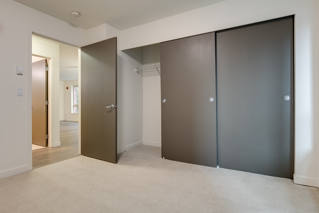 A room with a brown door and a white door.