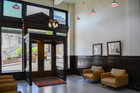 A room with a brown chair and a brown door.
