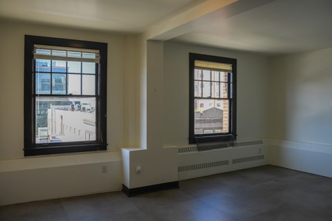 A room with a window and a radiator on the wall.