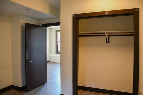 A large mirror with a black frame is leaning against a wall in a room.