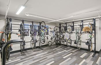 A bike shop with many bikes hanging on the wall.