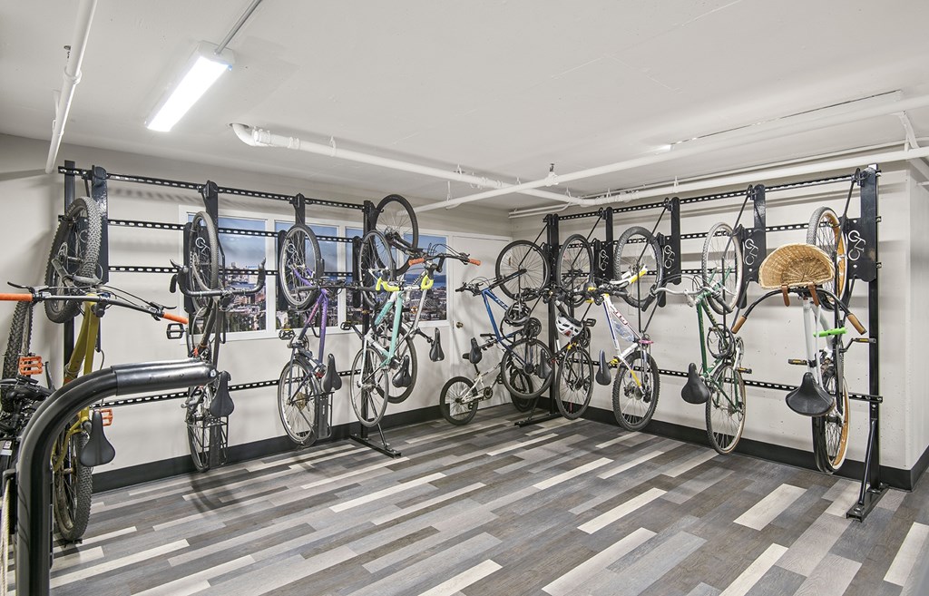 A bike shop with many bikes hanging on the wall.