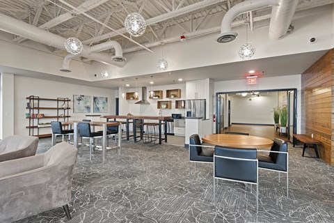 A modern office space with a patterned carpet and a variety of seating options.