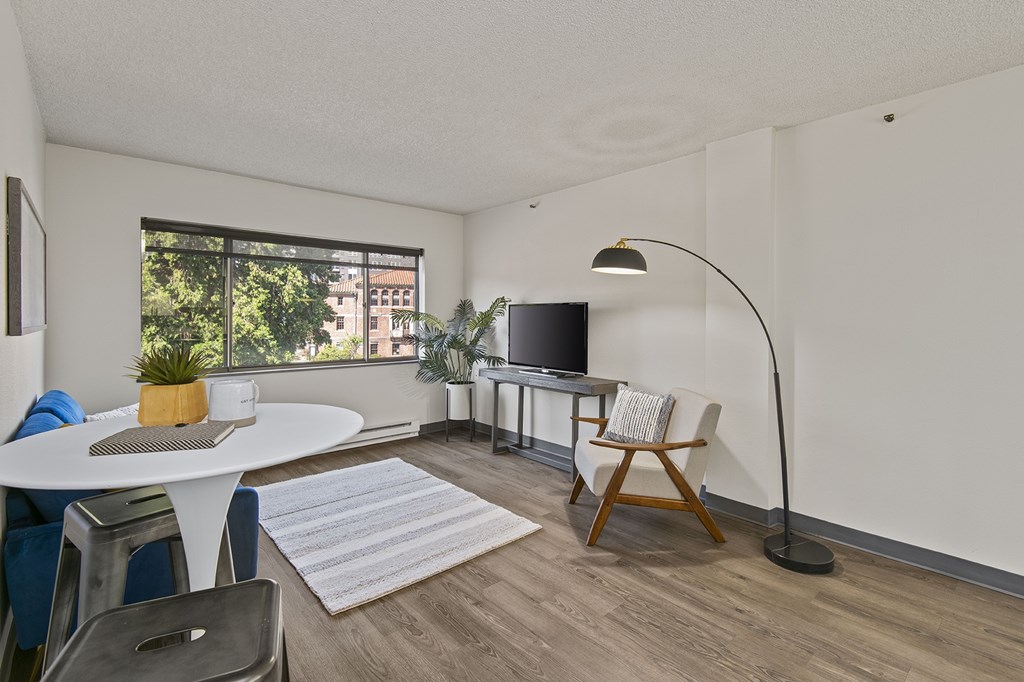 A living room with a white table and a television.