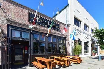 A brick building with a sign that says "Paddy's" on it.