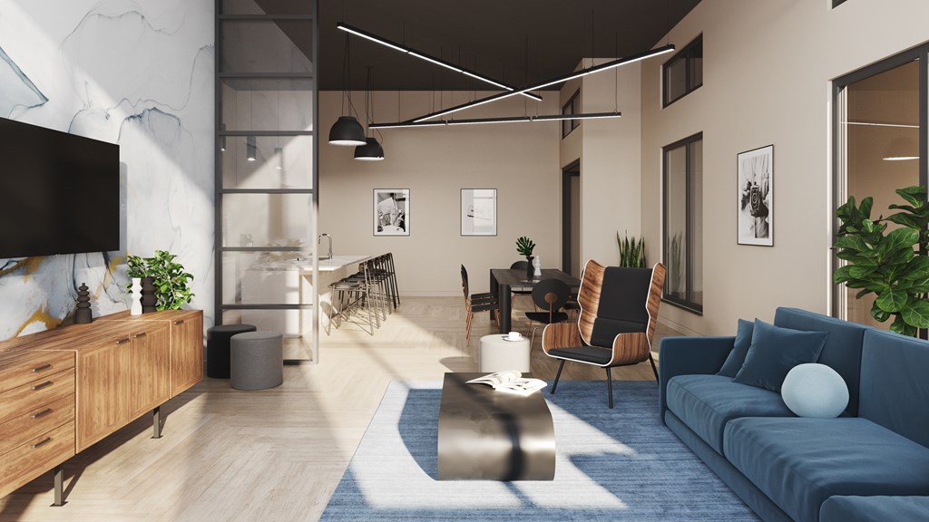 A modern living room with a blue sofa and a TV on the wall.