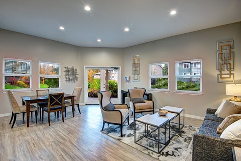 A living room with a couch, chairs, and a coffee table.
