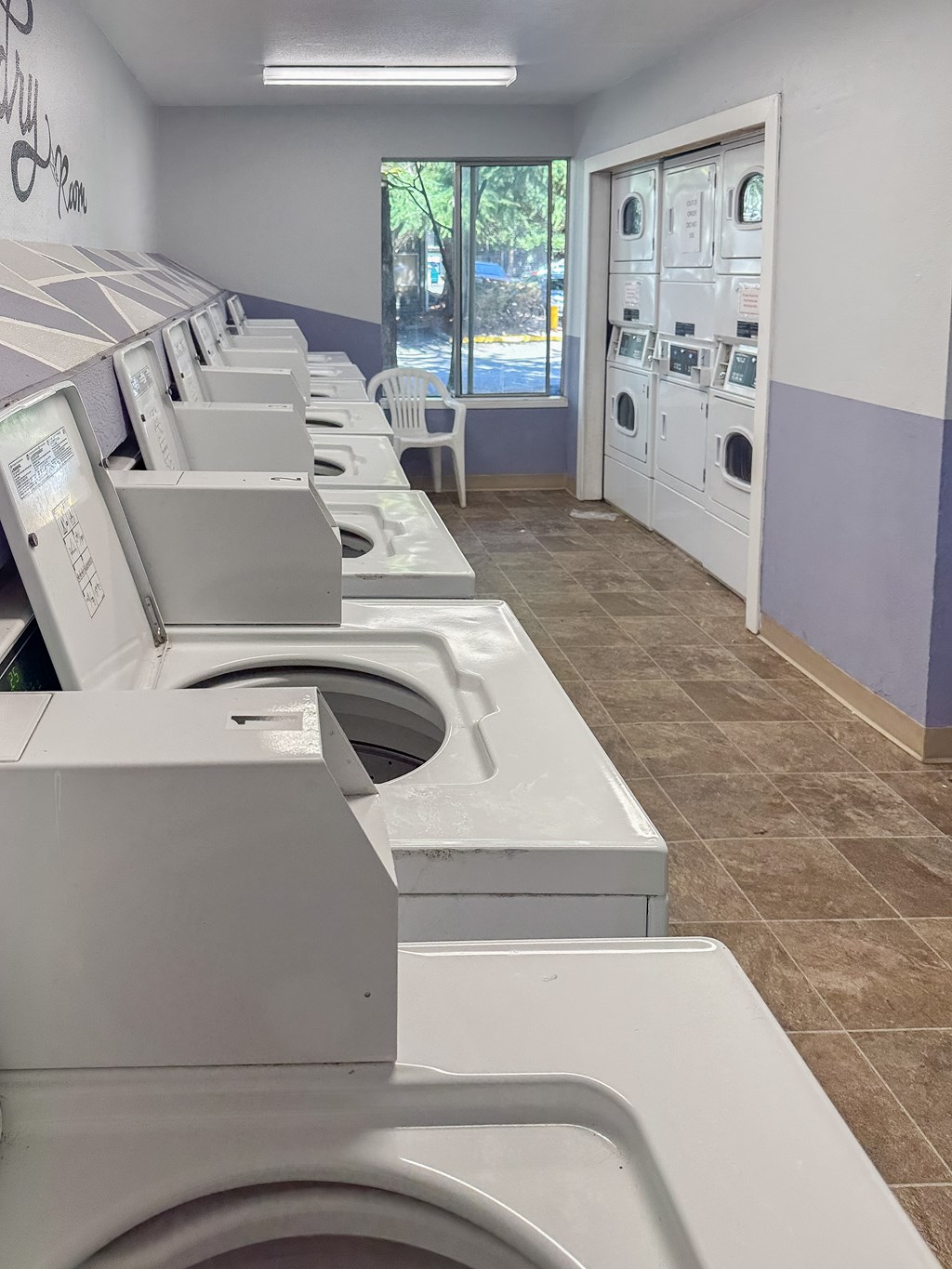 A row of washing machines in a public laundromat.