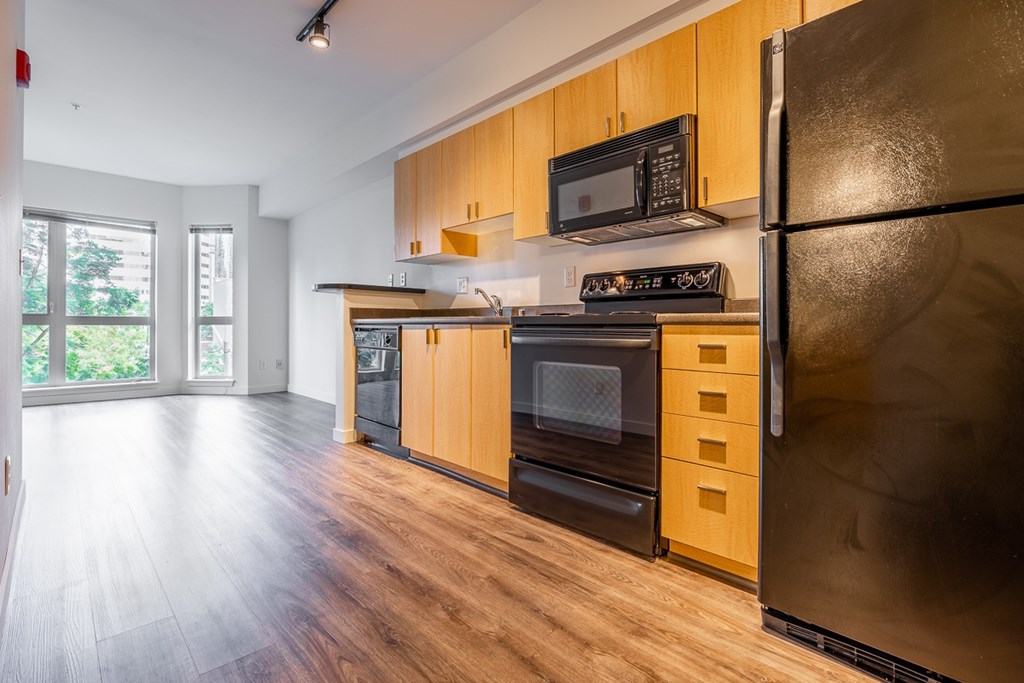 A kitchen with wooden cabinets and stainless steel appliances.