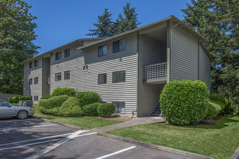 A building with a car parked in front of it.