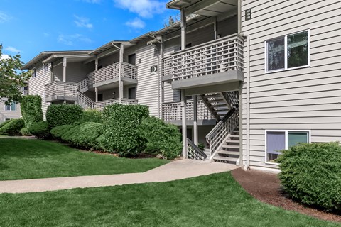 Apartment building with a green lawn in front.