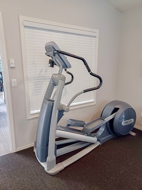 A Prado elliptical trainer is on the floor in a room.