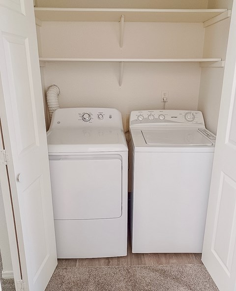 A small laundry room with a washer and dryer.