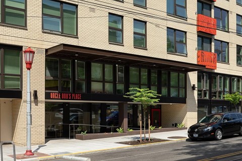 A building with a black car parked in front of it.