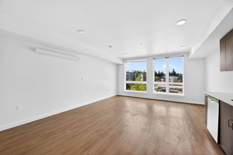 Spacious living room with wood flooring at Victory Northgate Apartments, Seattle, 98125