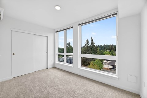 Bedroom with white walls and carpeting at Victory Northgate Apartments, Seattle, Washington