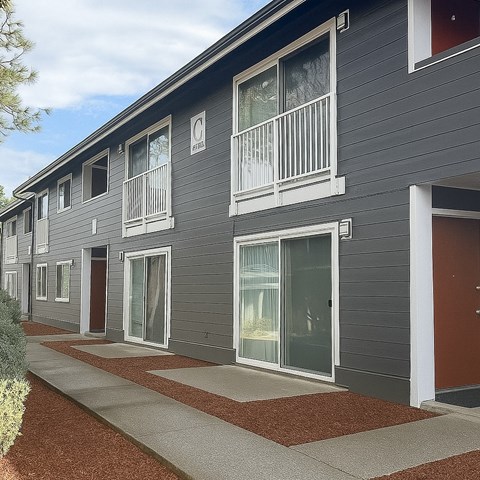A grey building with red doors and windows.