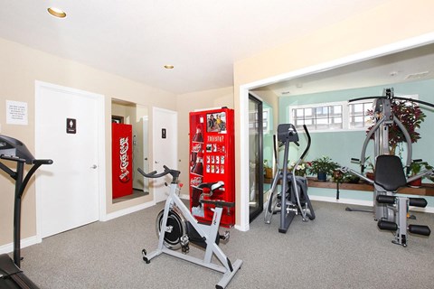 A gym with a Coca Cola vending machine.