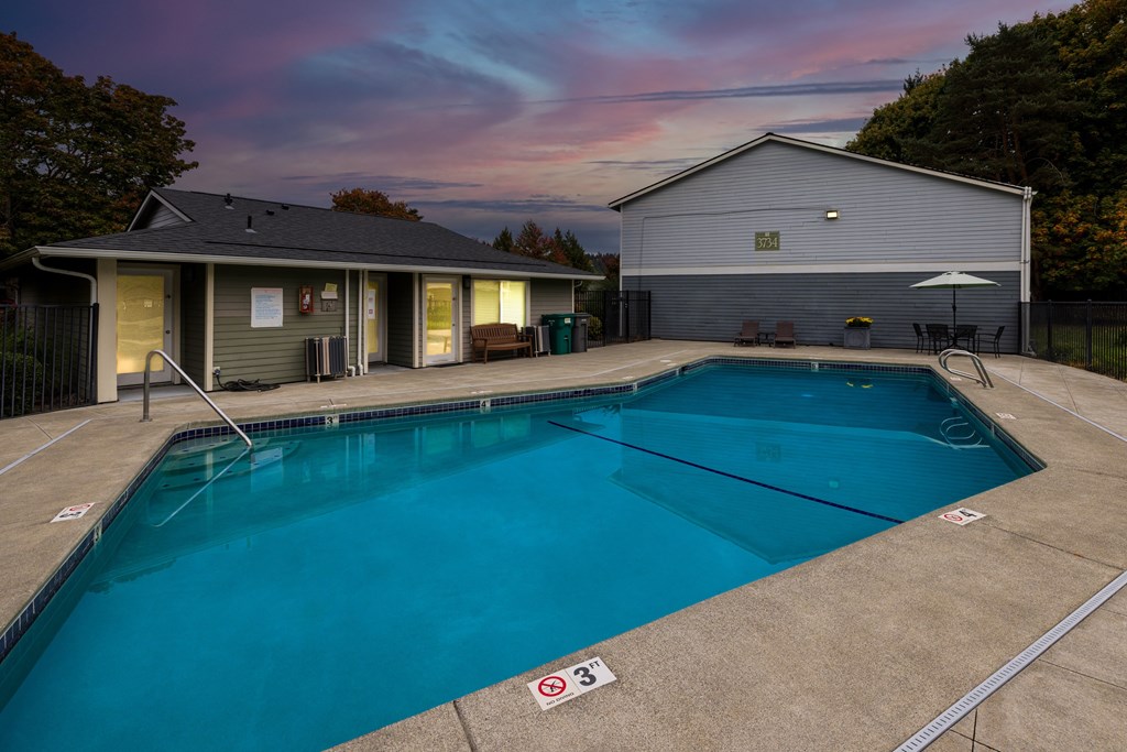 A pool with a no swimming sign in the foreground.